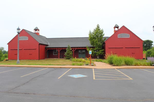clinic front. building is red and shaped like a barn